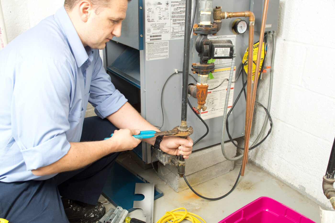 Plumber repaires furnace