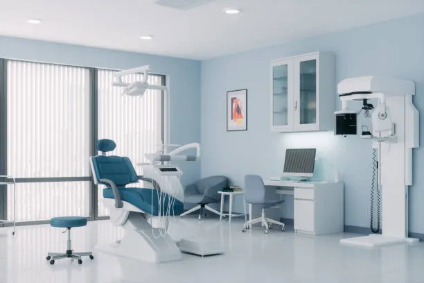 Dental office interior featuring a modern dental chair, examination equipment, and a workstation, designed for maintaining clean airflow and patient comfort.