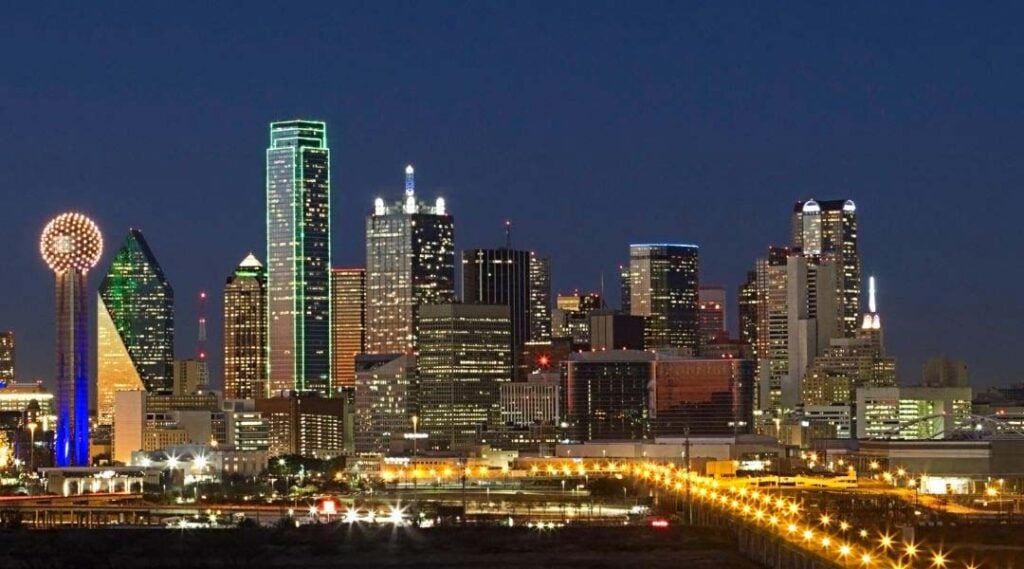 Dallas, TX skyline at night. Cityscape view with illuminated buildings. Expert AC Repair services available for homes and businesses in Dallas.