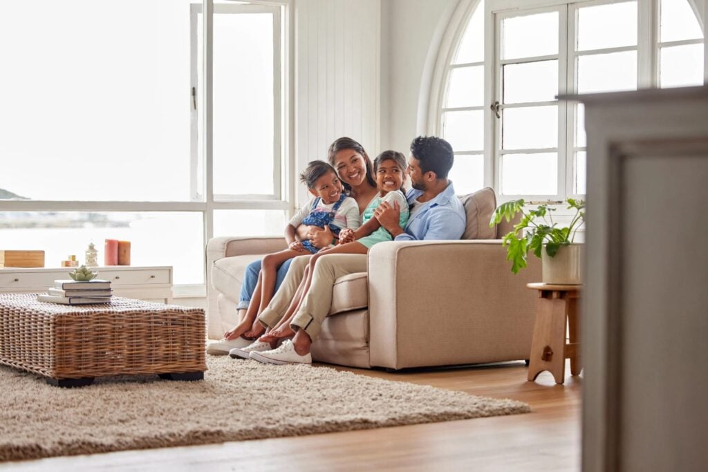 Happy family relaxing at home. Consider a heat pump installation for efficient heating and cooling in Dallas, TX.