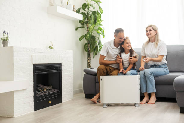 Family enjoying warmth together in a cozy living room with a heater, emphasizing comfort and heating efficiency during cold weather.
