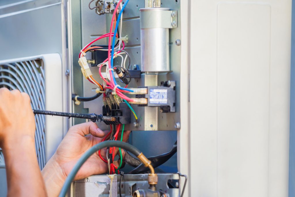 HVAC technician repairing an air conditioning unit in Preston Hollow, Dallas, TX, ensuring efficient cooling and heating for your home or business.