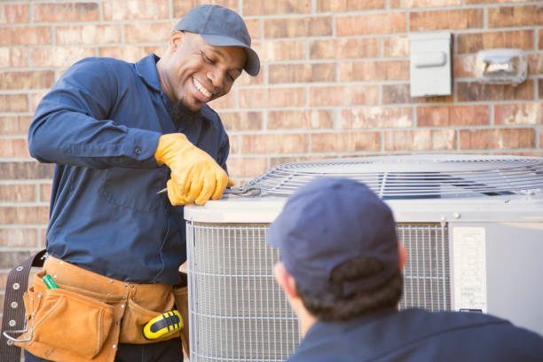HVAC technicians performing air conditioning maintenance, ensuring reliable cooling solutions for homes in Dallas, TX.