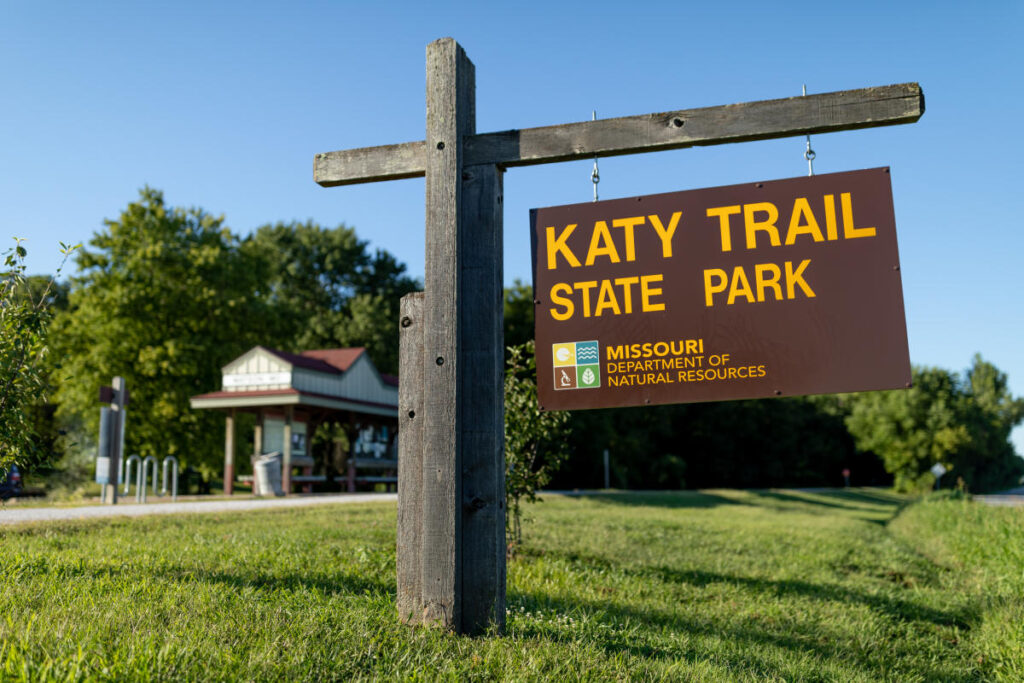 Katy Trail State Park sign with visible text and surrounding greenery, highlighting outdoor recreation in Oak Lawn, Dallas area.