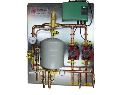 Complex zoning systems setup with copper pipes and a green control box ensures efficient climate control in Dallas, TX, for ultimate comfort.