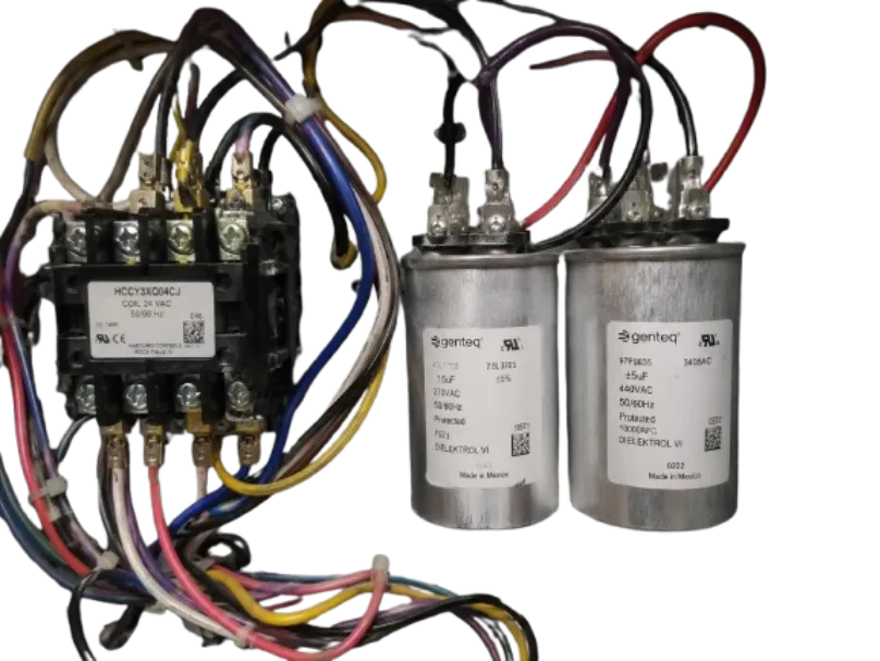 Electrical components from an air handler including a contactor and two Genteq capacitors wired with colorful bundled cables